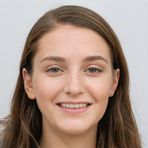 Joyful white young-adult female with long  brown hair and blue eyes