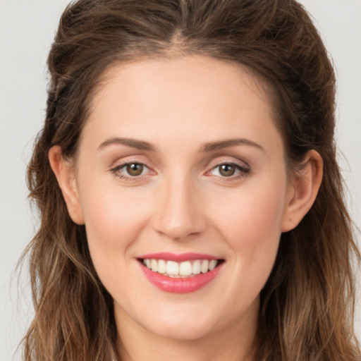 Joyful white young-adult female with long  brown hair and green eyes