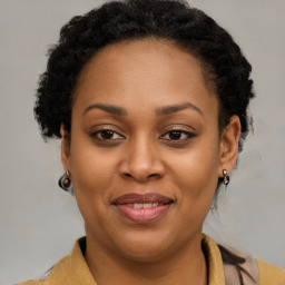 Joyful black adult female with short  brown hair and brown eyes