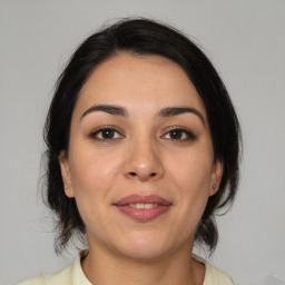 Joyful white young-adult female with medium  brown hair and brown eyes