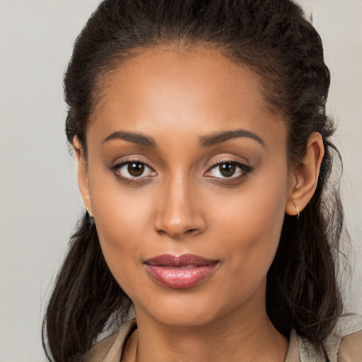 Joyful latino young-adult female with long  brown hair and brown eyes