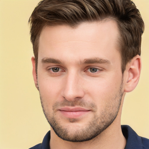 Joyful white young-adult male with short  brown hair and grey eyes