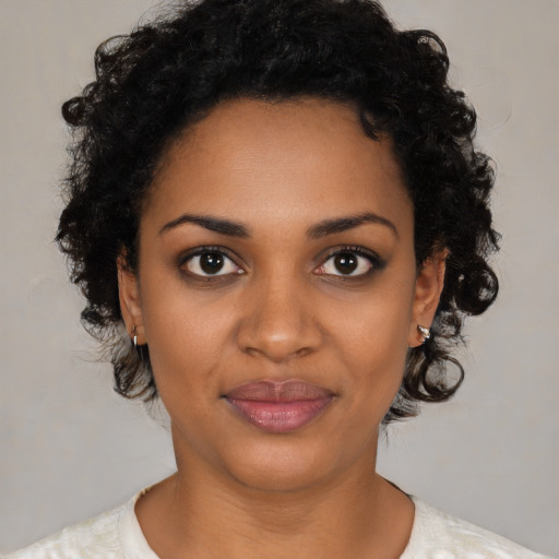 Joyful black young-adult female with short  brown hair and brown eyes