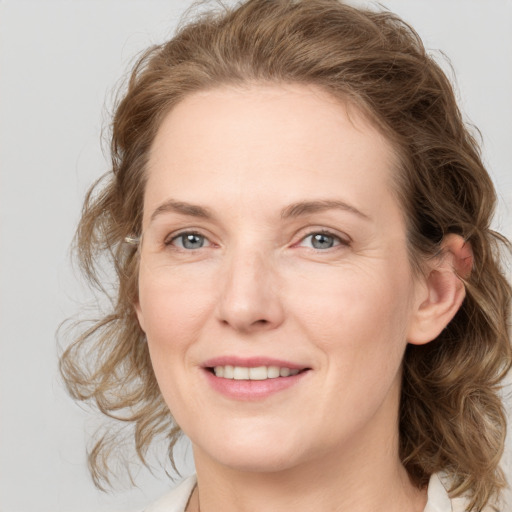 Joyful white young-adult female with medium  brown hair and blue eyes