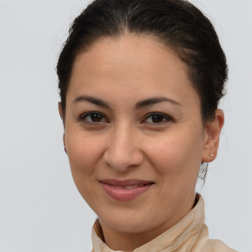 Joyful latino young-adult female with short  brown hair and brown eyes
