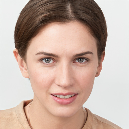 Joyful white young-adult female with short  brown hair and grey eyes