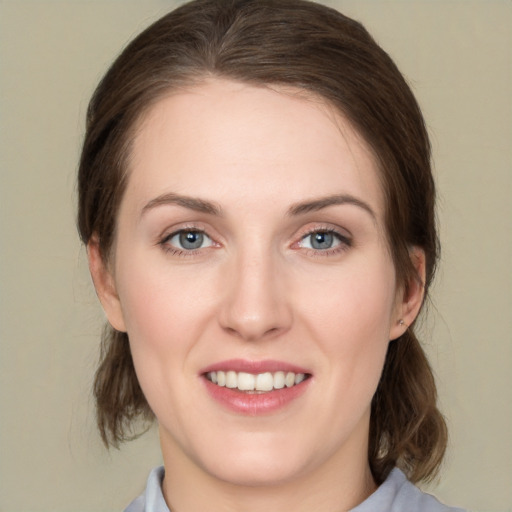 Joyful white young-adult female with medium  brown hair and green eyes