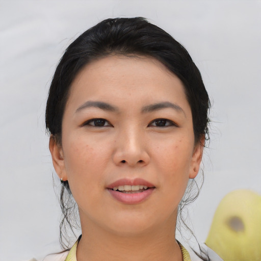 Joyful asian young-adult female with medium  black hair and brown eyes