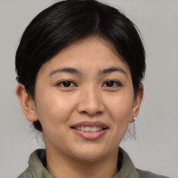 Joyful asian young-adult female with medium  brown hair and brown eyes