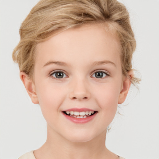 Joyful white child female with short  blond hair and grey eyes