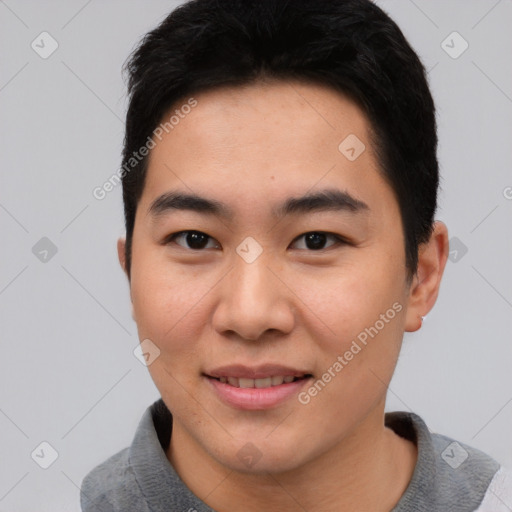 Joyful asian young-adult male with short  black hair and brown eyes