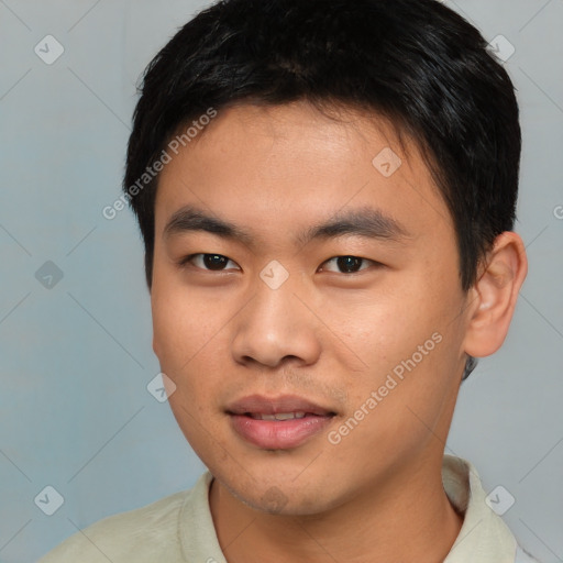 Joyful asian young-adult male with short  brown hair and brown eyes