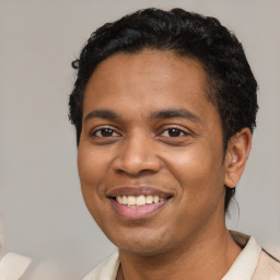 Joyful latino young-adult male with short  black hair and brown eyes