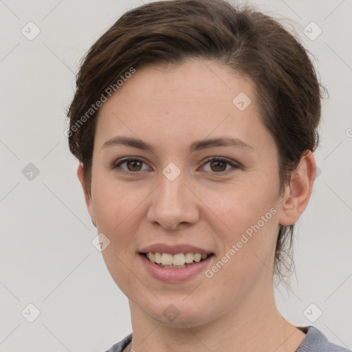 Joyful white young-adult female with short  brown hair and grey eyes