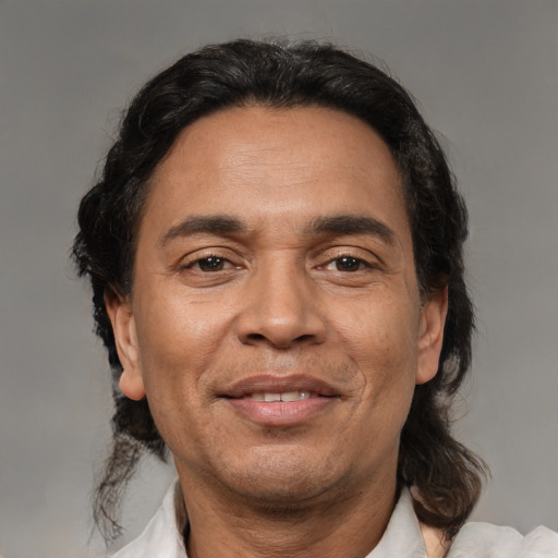 Joyful white adult male with medium  black hair and brown eyes