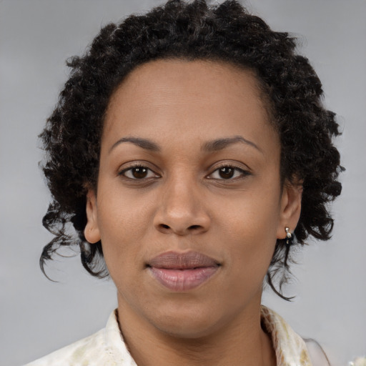 Joyful black young-adult female with medium  brown hair and brown eyes