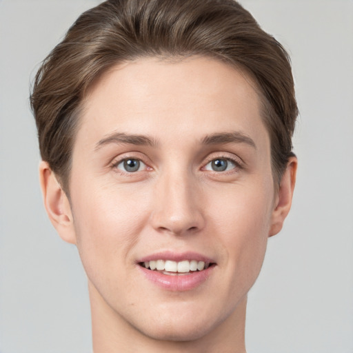 Joyful white young-adult female with short  brown hair and grey eyes