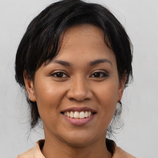Joyful asian young-adult female with medium  black hair and brown eyes