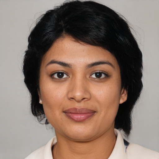 Joyful latino young-adult female with medium  black hair and brown eyes