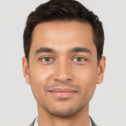 Joyful white young-adult male with short  brown hair and brown eyes