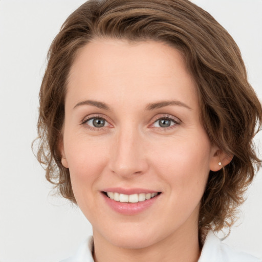 Joyful white young-adult female with medium  brown hair and green eyes