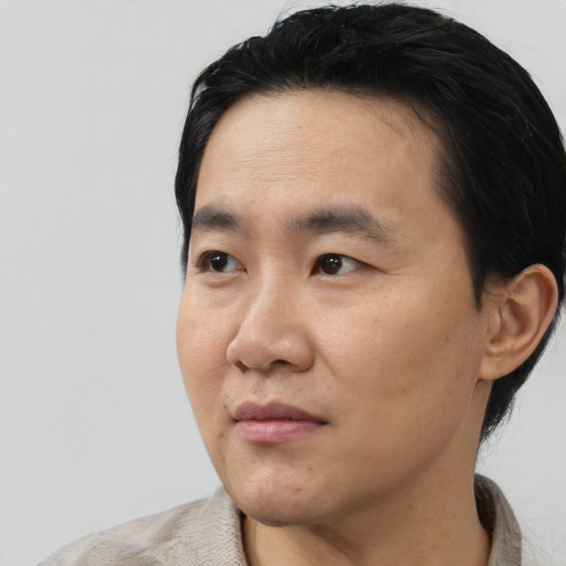 Neutral asian adult male with short  black hair and brown eyes