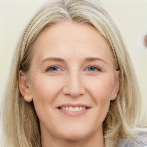 Joyful white adult female with long  brown hair and grey eyes