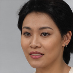 Joyful asian young-adult female with medium  black hair and brown eyes