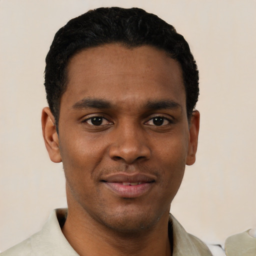 Joyful black young-adult male with short  black hair and brown eyes