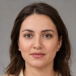 Joyful white young-adult female with medium  brown hair and brown eyes