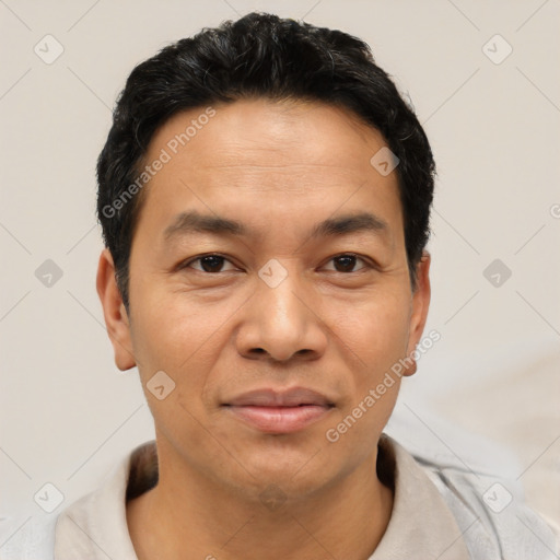 Joyful latino adult male with short  black hair and brown eyes