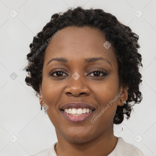 Joyful black young-adult female with short  black hair and brown eyes