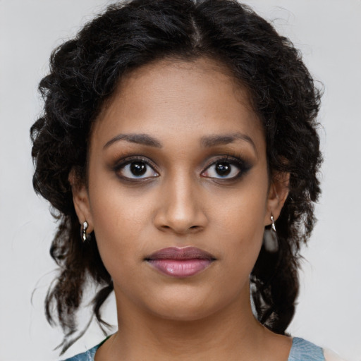 Joyful black young-adult female with medium  brown hair and brown eyes