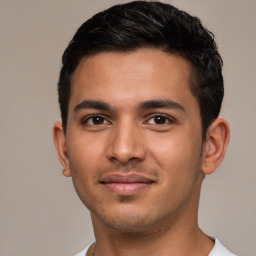 Joyful latino young-adult male with short  brown hair and brown eyes