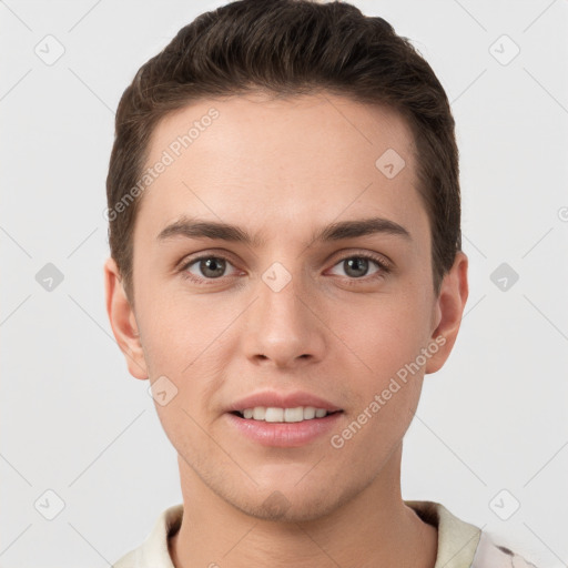 Joyful white young-adult male with short  brown hair and grey eyes