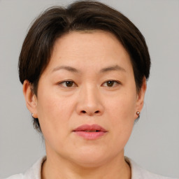 Joyful asian adult female with short  brown hair and brown eyes