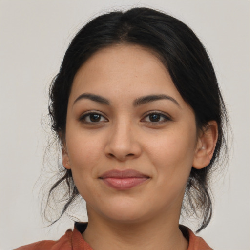 Joyful latino young-adult female with medium  black hair and brown eyes