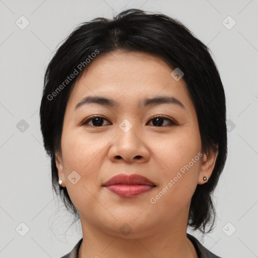 Joyful asian young-adult female with medium  black hair and brown eyes