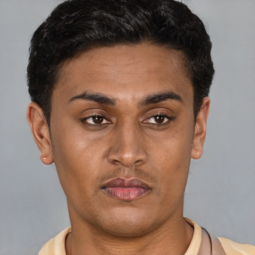 Joyful latino young-adult male with short  brown hair and brown eyes