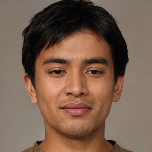 Joyful asian young-adult male with short  black hair and brown eyes