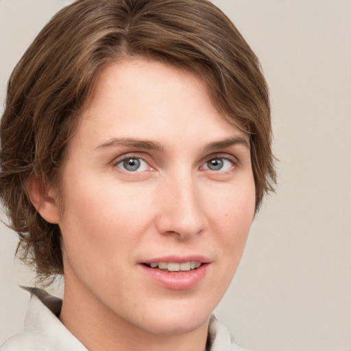 Joyful white young-adult female with medium  brown hair and grey eyes