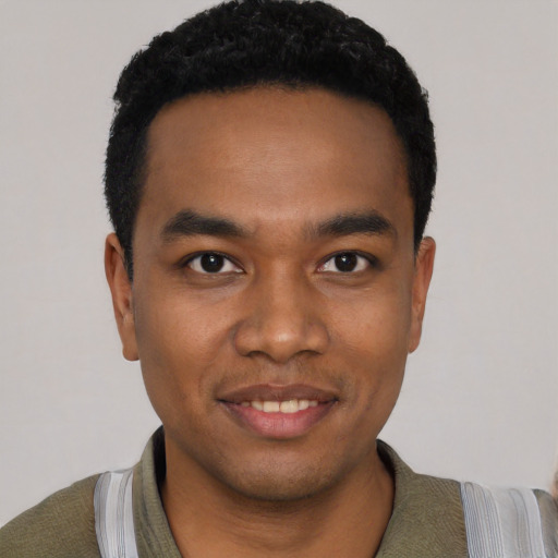 Joyful black young-adult male with short  black hair and brown eyes