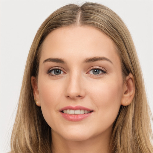 Joyful white young-adult female with long  brown hair and grey eyes