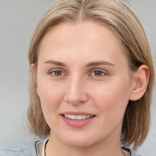 Joyful white young-adult female with medium  brown hair and blue eyes