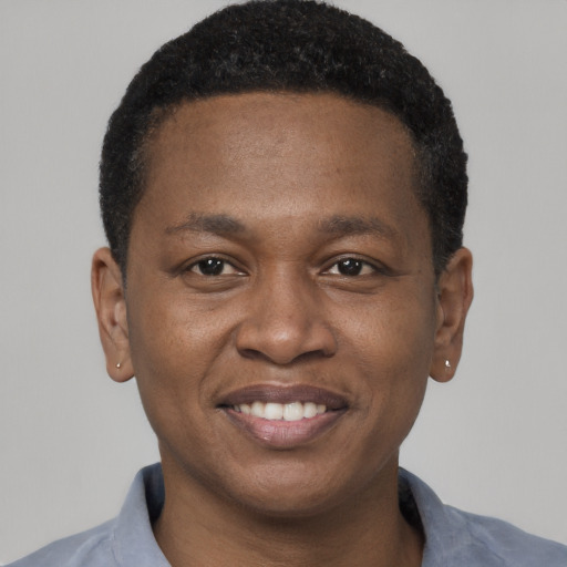 Joyful black young-adult male with short  black hair and brown eyes