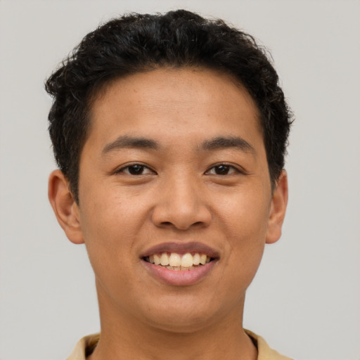 Joyful asian young-adult male with short  brown hair and brown eyes