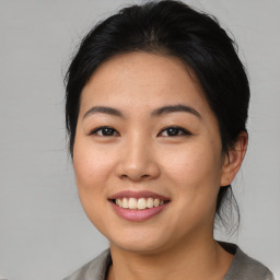 Joyful asian young-adult female with medium  brown hair and brown eyes