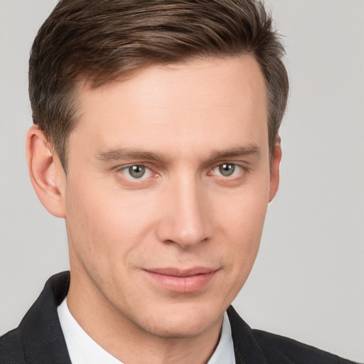 Joyful white young-adult male with short  brown hair and grey eyes