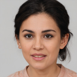 Joyful latino young-adult female with medium  brown hair and brown eyes