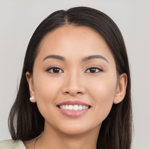 Joyful white young-adult female with long  brown hair and brown eyes